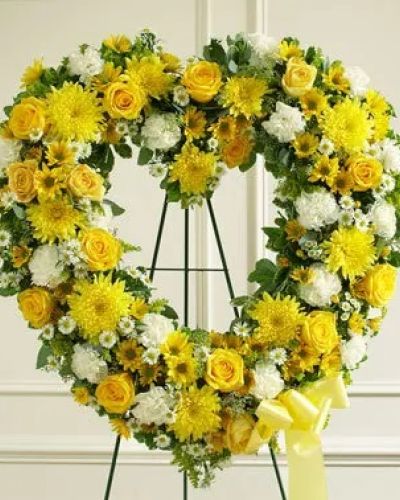 Convey your deepest condolences and undying love with this beautiful arrangement. This striking, heart-shaped tribute is crafted by our expert florists with yellow and white flowers such as roses, cremones, carnations and more to help you offer your comfort and support during a difficult time. Traditionally sent directly to the funeral home by family members or friends and displayed on a stand.