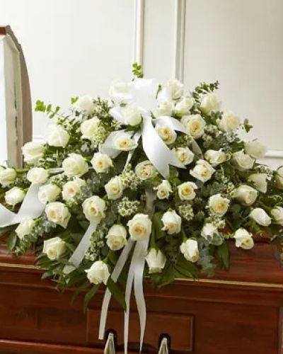 Every moment spent with your loved one is a memory you want to hold onto forever. Commemorate their life with this beautiful white half casket cover, crafted by our expert florists with long-stem white roses accented with crisp greenery. Traditionally sent by the immediate family to the funeral home.