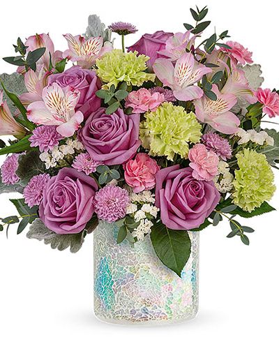 Shimmering with a mosaic of iridescent glass, this keepsake vase and majestic rose bouquet make an irresistible Mother's Day gift!

This irresistible bouquet features lavender roses, green carnations, light pink alstroemeria, lavender button spray chrysanthemums, miniature pink carnations, white sinuata statice, parvifolia eucalyptus and dusty miller.
