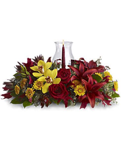 <div id="mark-3" class="m-pdp-tabs-marketing-description">Give thanks by sending this fall flower centerpiece. A chic, exotic spin on the traditional Thanksgiving centerpiece, it features orchids, roses, lilies and leucadendron in rich fall colors below a glowing taper candle, surrounded by a glass hurricane.</div>
&nbsp;
<div id="desc-3">
<ul>
 	<li>Yellow cymbidium orchids, red roses, burgundy asiatic lilies, bronze cushion mums, red leucadendron, seeded eucalyptus and salal are accented with red oak leaves.</li>
 	<li>A pomegranate taper candle inside a classic glass hurricane adds a warm glow to the room.</li>
</ul>
</div>
