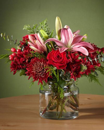 Make your loved ones blush with this Rosy Cheeks Bouquet, outfitted with stunning red roses and lilies. Cute enough to pinch, this gift will bring a flirtatious pop of color to a traditional holiday palette and kick the Christmas gathering off right.
