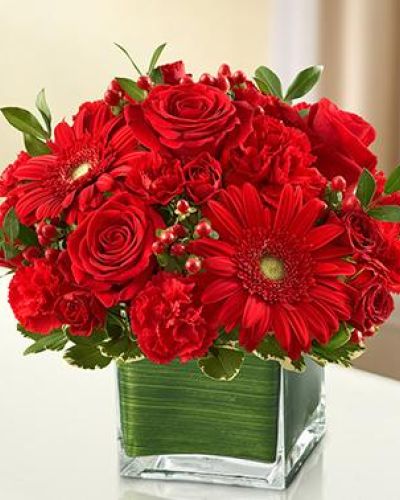 A symbol of courage and strength, an all-red bouquet conveys your sympathies with striking beauty. Our florists fill a stylish cube vase with roses, spray roses, Gerberas, carnations and more to send a fitting tribute during times of sorrow.