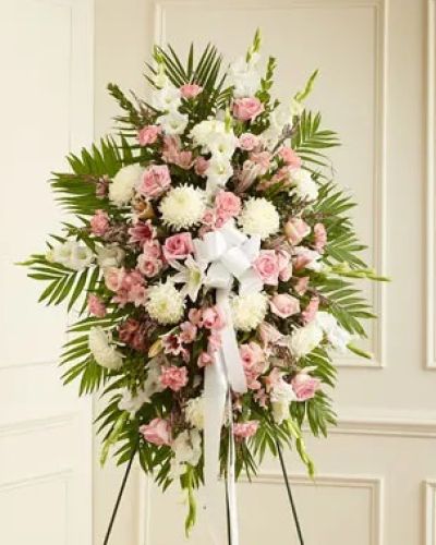 This Profound Sympathies Standing Spray in shades of pink and white is a beautiful symbol of your sympathy and support. It is expertly crafted with pink roses, stargazer lilies, spray roses, white carnations and more. An appropriate gift for family, friends and business associates to send directly to the funeral home.