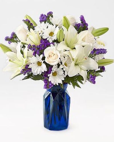 Gift your friends and family the freshest and most beautiful bouquet of lilies, roses and statice. Perfect for complementing any message you want to send, our Beyond Blue Bouquet features a deep blue vase and a gorgeous array of white and purple blooms.

STANDARD
C Quantity	Color	Description
3	Ivory	50 cm Standard Rose - Escimo
2	White	LA Hybrid Lily
5	White	Daisy Pom
3	Purple	Filler - Sinuata Statice
3	Green	Green - Leather Leaf

DELUXE

C Quantity	Color	Description
5	Ivory	50 cm Standard Rose - Escimo
3	White	LA Hybrid Lily
5	White	Daisy Pom
4	Purple	Filler - Sinuata Statice
3	Green	Green - Leather Leaf

PREMIUM

C Quantity	Color	Description
6	Ivory	50 cm Standard Rose - Escimo
4	White	LA Hybrid Lily
5	White	Daisy Pom
4	Purple	Filler - Sinuata Statice
3	Green	Green - Leather Leaf