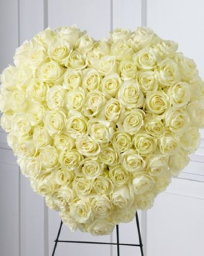 The FTD® Elegant Remembrance™ Standing Heart is an exquisite display of peace and love. 77 stems of white roses are artfully arranged in the shape of a heart and presented on a wire easel, creating a simply beautiful tribute for their final farewell service.