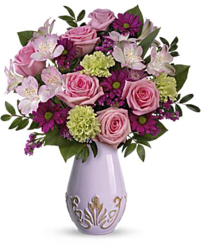 Reminiscent of a Parisian flea market find, this embossed ceramic purple vase lends vintage charm to this magnificent Mother's Day rose bouquet!
This lovely bouquet for Mom features pink roses, light pink alstroemeria, green carnations, purple daisy spray chrysanthemums, lavender cushion spray chrysanthemums, raspberry sinuata statice, huckleberry and lemon leaf.