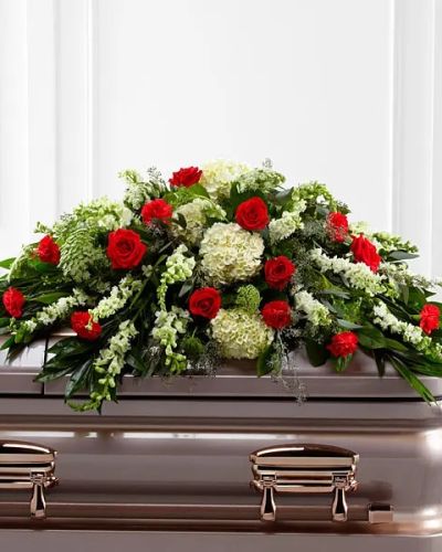 The FTD® Sincerity™ Casket Spray is a wondrous presentation of fresh color and beauty. Rich red roses and carnations are eye-catching and elegant in an arrangement of white hydrangea, larkspur, snapdragons, Queen Anne's Lace and assorted lush greens to create a lovely display meant to bedeck the top of their casket, bringing comfort and peace to those grieving the loss of the departed.