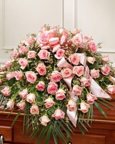 Celebrate a life well lived and loved with this beautiful pink casket spray. It features gorgeous long-stem pink roses, waxflower and vibrant greenery. Traditionally sent by the immediate family to the funeral home.