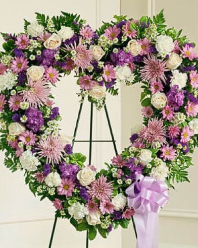 The passing of a beloved family member or friend is a sad and difficult time. You want to convey your deepest sympathies to those left behind while also remembering and celebrating a beautiful life. This striking, heart-shaped tribute is crafted by our expert florists from delicate lavender and white blooms and is a beautiful expression of all the love you feel in your heart. Traditionally sent directly to the funeral home by family members or friends and displayed on a stand.