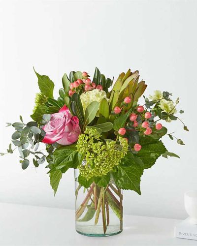 Bring the great outdoors, in hydrangeas, roses, eucalyptus, and hypericum berries.