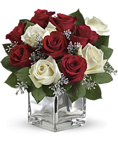 Give Christmas a charmingly contemporary spin with lush red and white roses in a dazzling mirrored silver cube. With a merrily moderate price tag, it makes the perfect gift for all the people on your list – naughty or nice.

The impressive bouquet includes red roses and white roses accented with assorted greenery.